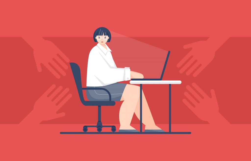 Woman sitting at her work desk with hands reaching for her